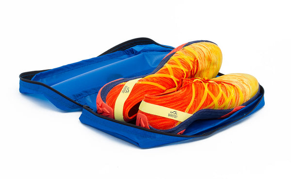 A pair of shoes in an open Island (blue) Aether End Pocket Packing Cube for the Aeronaut 30.